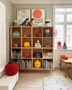 a child's room with bookshelves and toys