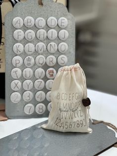 a bag sitting on top of a table next to some type of letters and numbers