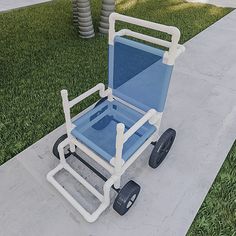 a blue and white chair sitting on top of a sidewalk next to a grass covered field