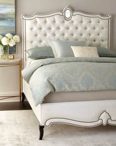 a white bed sitting in a bedroom on top of a carpeted floor next to a dresser