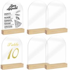 four clear acrylic plaques with wooden bases