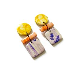 Elevate your style with these eye-catching, handmade earrings, crafted from clay and painted in a vibrant marbled design using alcohol ink. Each pair features a stunning mix of yellow, purple, and peach tones, creating a unique and artistic look. These statement earrings are perfect for adding a pop of color to any outfit, whether you're dressing up for a special occasion or adding some flair to your everyday wear. Lightweight and comfortable, they come with your choice of post or clip-on backs Everyday Multicolor Resin Jewelry, Multicolor Clay Jewelry With Matching Earrings, Hand Painted Multicolor Clay Jewelry, Handmade Multicolor Clay Earrings, Trendy Purple Polymer Clay Jewelry, Unique Hand Painted Purple Earrings, Multicolor Clay Dangle Jewelry, Hand-painted Yellow Polymer Clay Jewelry, Unique Purple Polymer Clay Earrings