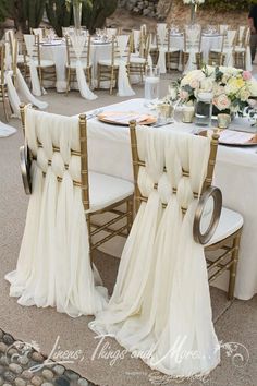 the chairs are covered with white cloths