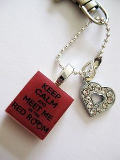 a keychain with a red tag attached to it that says keep calm and meet me in the red room