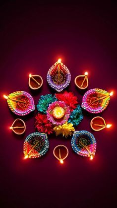 colorful diya with candles and flowers in the middle on a dark background for diwaling