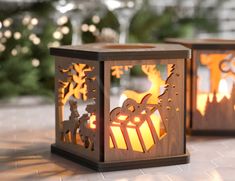 two wooden lanterns sitting on top of a white tile floor next to trees and lights