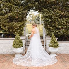 a woman in a wedding dress standing on some steps