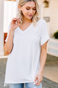 This versatile v-neck tee is here to make your life easy! It's honestly the perfect top for year round styling and layering. You can knot the hem or half tuck into your favorite jeans or shorts. You can layer it with all sorts of jackets, shackets, or kimonos. And don't even get us started on accessories! The options are absolutely endless! This top is truly a staple piece! This top features a v neckline, short cuffed sleeves, and a generous fit. Material has generous amount of stretch. Sydney i White Relaxed Fit V-neck Top, Chic White V-neck T-shirt, White Short Sleeve V-neck Top For Everyday, White V-neck Top For Everyday Wear, White V-neck Short Sleeve Top, Chic V-neck T-shirt For Everyday, White V-neck Top For Everyday Spring Wear, White V-neck T-shirt For Day Out, Chic V-neck T-shirt For Layering