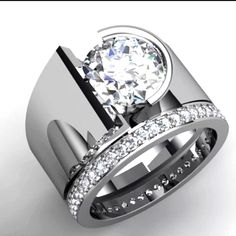 a diamond engagement ring set with two matching bands on top of the band and an oval shaped