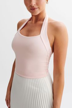 Sleek silouetteThe RENEE Halter Top is a modern and stylish piece perfect for any trendy wardrobe. It features a sleek straight neckline and a halter design that elegantly frames the shoulders. The open back adds a touch of allure, while the cropped length keeps it contemporary and chic. Fully lined for comfort, this top is ideal for pairing with high-waisted bottoms for a fashionable and polished look. Chic Yoga Tank Top With Built-in Bra, Halter Neck Top With Built-in Bra And 4-way Stretch, Racerback Halter Top With Built-in Bra And High Stretch, Fitted Tank Top With Built-in Bra And Strappy Back, Workout Halter Crop Top With Built-in Bra, Fitted T-back Crop Top For Yoga, Chic Racerback Halter Top With Built-in Bra, Chic Crop Top With Built-in Bra And Minimal Stretch, Chic Crop Top With Built-in Bra And Strappy Back