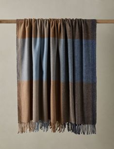 a brown and blue plaid blanket hanging on a clothes line