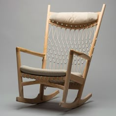 a wooden rocking chair with a cushion on it