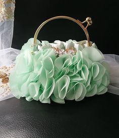 This stunning Sage Green Chiffon Evening Clutch Bag is the perfect accessory for weddings and special events. Adorned with delicate flowers, this elegant handbag is ideal for both brides and bridesmaids. The gold hardware adds a touch of glamour, making this purse a must-have for any formal occasion. Stay stylish and organized with this chic clutch bag that will complement any outfit beautifully. Size: 23cmx22cmx9cm(LxHxW) Colour: sage green -------------------- International Shoppers: Please se Green Handheld Clutch For Wedding, Handheld Green Clutch For Wedding, Green Clutch Evening Bag For Wedding, Bridesmaid Purses, Bag With Flowers, Elegant Handbag, Wedding Handbag, Wedding Bags, Delicate Flowers