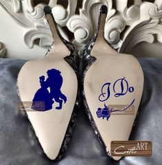 pair of shoes decorated with the silhouettes of two people kissing on top of each other