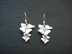 matte finish white gold plated over brass flowers, done with hand brush technique, hangs on a white gold plated ear wires earrings measure 20mm from ear wires matching bracelet; https://www.etsy.com/listing/87535808/fourfold-flowers-bracelet matching necklaces; https://www.etsy.com/listing/169941327/three-fold-flowers-cascading-necklace https://www.etsy.com/listing/87536182/matte-fivefold-flowers-lariat-white-gold https://www.etsy.com/listing/170930272/double-three-fold-flowers-with-swarovski al Silver Sterling Earrings With 3d Flowers, Sterling Silver Earrings With 3d Flowers, Silver Flower Earrings With 3d Flowers For Gift, Silver Flower Earrings With 3d Flowers As Gift, Silver 3d Flower Earrings For Gifts, Formal White Sterling Silver Flower Earrings, Silver Earrings With 3d Flowers For Wedding, Silver Drop Earrings With Flower Charm For Bridal, Silver Drop Bridal Earrings With Flower Charm