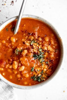 a white bowl filled with beans and garbanzo