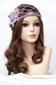 a mannequin head with long brown hair and a pink flower in the middle