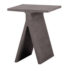 the concrete table is shaped like an abstract piece of art, and sits on a white background