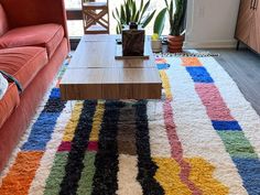 a living room filled with furniture and a colorful rug