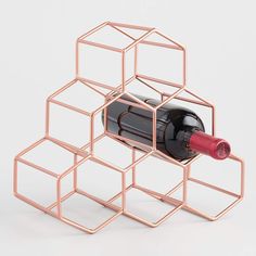 a wine bottle holder made out of metal cubes