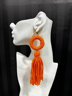 Made from dense, soft yarn, these statement earrings feature a bold ring and flowing tassel design. Available in multiple colors, they are perfect for adding a playful, yet sophisticated flair to any outfit. Trendy Tassel Dangle Earrings, Trendy Tassel Fringe Drop Earrings, Trendy Tassel Drop Earrings With Fringe, Trendy Fringe Earrings, Trendy Tassel Earrings, Trendy Tassel Drop Earrings, Chic Dangle Tassel Earrings, Yarn Tassel, Fluffy Yarn