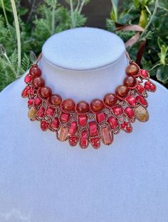 Add some drama at your neckline with this beautiful necklace made from a mixture of red gemstones including jasper, carnelian, coral and howlite shaped into a collar. This design is unique, the jewelry makers only made one necklace with these beads. This special piece is from a husband and wife team that take gemstones and transform them in beautiful novel ways. It's handmade, and we procured their only necklace in this pattern. Details: Fabric ribbon ties at the back of the neck to adjust as re Beaded Collar Necklace, Color Palate, Beaded Collar, Woven Pattern, Red Gemstones, Sunset Colors, Unique Necklace, Fabric Ribbon, Jade Beads