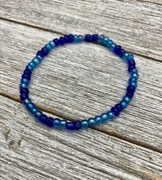 Blue glass seed bead bracelet, with a size of 6 inches. Made with a double strand of high quality stretch elastic, with extra knotting and jeweler's glue.  Sizing- Please contact me if you would like a custom size or additional bracelets made  Care instructions: As with all stretch bracelets, be sure when putting on your bracelet, to roll it on your hand instead of stretching open to  ensure that your bracelet will have the longest life and stays in the best condition. Blue Beaded Spiritual Stretch Bracelet, Adjustable Blue Faceted Beads Friendship Bracelets, Flexible Blue Beaded Bracelets, Blue Tiny Beads Stretch Bracelet For Friendship, Adjustable Blue Friendship Bracelets With Faceted Beads, Adjustable Beaded Blue Stretch Bracelet, Adjustable Glass Stretch Bracelet With Spacer Beads, Handmade Blue Stretch Bracelet With Czech Glass, Adjustable Blue Stretch Bracelet With Spacer Beads