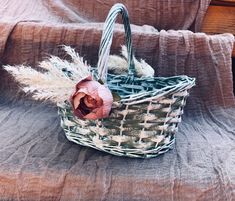 a small basket with a flower in it