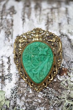 "Jade Colored Molded Celluloid with Brass Pin/Pendant - Vintage 1930's Symbols of Dragons, Phoenix and Butterfly. Can be worn as a brooch/pin or pendant (pivoting ring for chain to go through). Keep the love, wear, and story going with Vintage Treasures from shopBIOME. Proceeds support my permaculture homestead in Maine: growing food and perennial plant diversity. This shop is also partnered with Eden Reforestion Projects to plant 5 TREES with each order!  Check out how many we've planted so far Vintage Carved Collectible Brooches, Vintage Carved Brooches Gift, Vintage Carved Brooches For Gifts, Green Art Nouveau Wedding Brooches, Victorian Green Collectible Brooches, Retro Green Jewelry For Vintage Events, Vintage Brooch With Antique Finish, Vintage Filigree Brooches, Vintage Green Brooch Jewelry