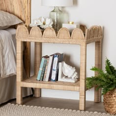 a wicker shelf with books on it next to a bed