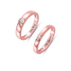 two rose gold wedding rings with diamonds on each side and the words love is in the middle