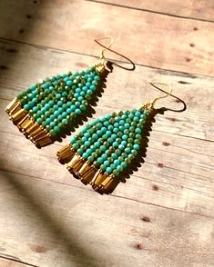 "Beautiful handmade earrings with a combination of two-color, Turquoise and gold color glass beads hanging from the gold plated ear wires Very chic and elegant.  Unique style. **Earrings are measured 2 3/4\" from ear wires to the end of the fringes." Elegant Turquoise Beaded Earrings With Gold Beads, Turquoise Teardrop Earrings With Faceted Beads, Bohemian Gold Earrings With Faceted Beads, Turquoise Dangling Bead Drop Earrings, Turquoise Earrings With Gold Beads For Gift, Turquoise Teardrop Czech Glass Earrings, Turquoise Earrings With Colorful Czech Glass Beads, Festive Turquoise Beaded Earrings, Elegant Turquoise Earrings With Gold Beads