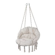 a white hanging chair with rope and tassels on the bottom, in front of a white background