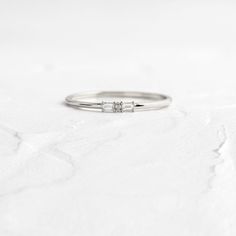 a white gold ring with three diamonds