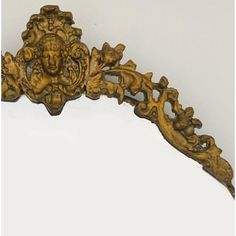 an ornate wooden frame with carvings on it