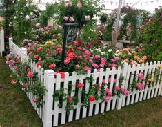 a white picket fence filled with lots of flowers