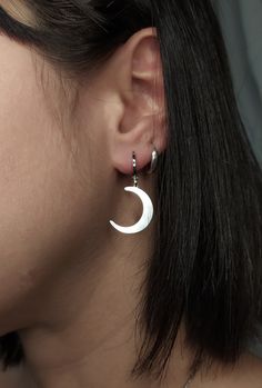 Selena. Shine with the light of the Moon. This unique pair of earrings is composed of rhodium filled huggies and sterling silver crescent moons. Perfect pair to give a witchy vibe to any outfit. Makes a very cute gift! Earring length: 1.2 inches / 3 cm ✺They are sold as a pair✺ ❈ We send all our items with registered mail. ❉ Due to the organic nature of stones, there might be a slight variation in colour, size and shape. ✺ All items come packaged in a quality velvet pouch ready for gift giving. ✽ If you want to make a special order, just contact us! Moon Dangle Earrings, Nickel-free Crescent Jewelry, Everyday Crescent Single Earring, Celestial Style Pierced Sterling Silver Jewelry, Silver Dangle Jewelry With Moon Charm, Silver Moon Phase Dangle Jewelry, Half Moon Earrings With Moon Charm, Half-moon Metal Earrings With Moon Charm, Half Moon Metal Earrings With Moon Charm