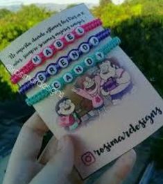 a person holding up a card with cartoon characters on it