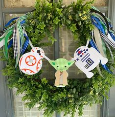 a wreath with some decorations hanging on it