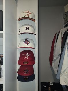 several hats are on display in a closet