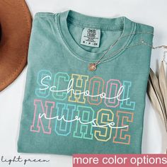 School Nurse Shirt - Essential School Health Staff Tee - School Nurse Appreciation PRODUCTION AND SHIPPING  Production: 1-3 days Standard Shipping (3-5 business days after production time) T-shirts and Sweatshirts are professionally PRINTED they are the highest quality print possible, like the quality you would expect from a retail shop bought T-shirt.  HOW TO ORDER YOUR CUSTOM DESIGN T-SHIRT  * Choose your t-shirt color * Choose your size * Choose your design & text color We absolutely love customizing orders for people! The best feeling is being able to add a personal touch to our designs to make our customers happy. If you would like to tweak this design with a name on the back or add some additional text all you have to do is add this listing to your cart with the shirt as well. DETAIL Green Letter Print Top For College, Sporty Green Shirt With Letter Print, Multicolor Pre-shrunk Tops For School Spirit, Multicolor Crew Neck Tops For College, Green School Spirit Tops For School, Green Pre-shrunk Shirt For School, Green Text Print T-shirt For School, Green Pre-shrunk Tops For School, Green Long Sleeve School T-shirt