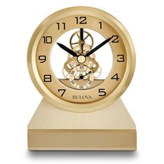 a golden clock with the word bulova on it