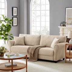 a living room with two couches and a coffee table in front of a fireplace