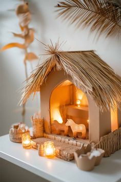 an outdoor fireplace with candles lit in front of it and palm leaves on the side