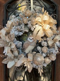 a wreath with an owl sitting on top of it