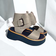 This highly favored model offers a stylish and comfortable option for everyday wear. The sandals feature a moderately soft and stable platform with a height of 3 cm at the front and 5 cm at the back. The design ensures a snug fit with an adjustable buckle around the ankle for added security. Available in a wide range of colors, these sandals not only provide exceptional comfort but also add a fashionable touch to your outfit. Materials: Genuine leather Sole: Stylish and flat Sole height: front 3 cm / back 5 cm Suitable for: Everyday use Additional features: Adjustable buckle for ankle Discover the perfect blend of style and comfort with our handmade black leather and patent leather platform sandals. These unique lace-up sandals are designed for the modern woman who values both elegance and Trendy Sandals With Strap And Round Toe, Trendy Leather Beach Sport Sandals, Trendy Leather Sport Sandals For Beach, Summer T-strap Sandals With Flat Heel And Adjustable Strap, Beige Closed Toe Sport Sandals For Summer, Trendy Leather Wedge Sandals With Removable Insole, Summer T-strap Sandals With Ankle Strap Medium Width, Leather Strap Wedge Sandals For Summer, Flat Sport Sandals With Leather Footbed For Summer