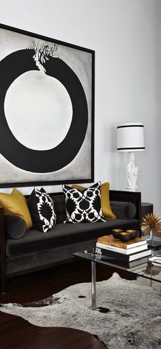 a black and white living room with yellow accents