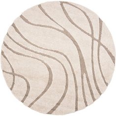 a round rug with wavy lines on the top and bottom in beige, white and grey