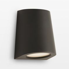 a black wall light on a white wall