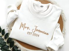 Dear, welcome to my store. Would you like a unique and personalized sports shirt? These embroidered sweatshirts provide excellent choices for various occasions, such as anniversaries, gifts for your significant other, or as souvenirs of special milestones in your relationship. Personalized dad embroidered sweatshirts, custom mom hoodies with the child's name printed on the sleeves, matching mom and dad clothing, and baby announcement gifts can all be chosen from my home. *Return and exchange pol Customizable White Top With Custom Embroidery, Baby Announcement Gifts, Mrs Sweatshirt, Matching Mom, Mom Hoodies, Future Mrs, Sports Shirt, Bridal Shower Gift, Embroidered Sweatshirt